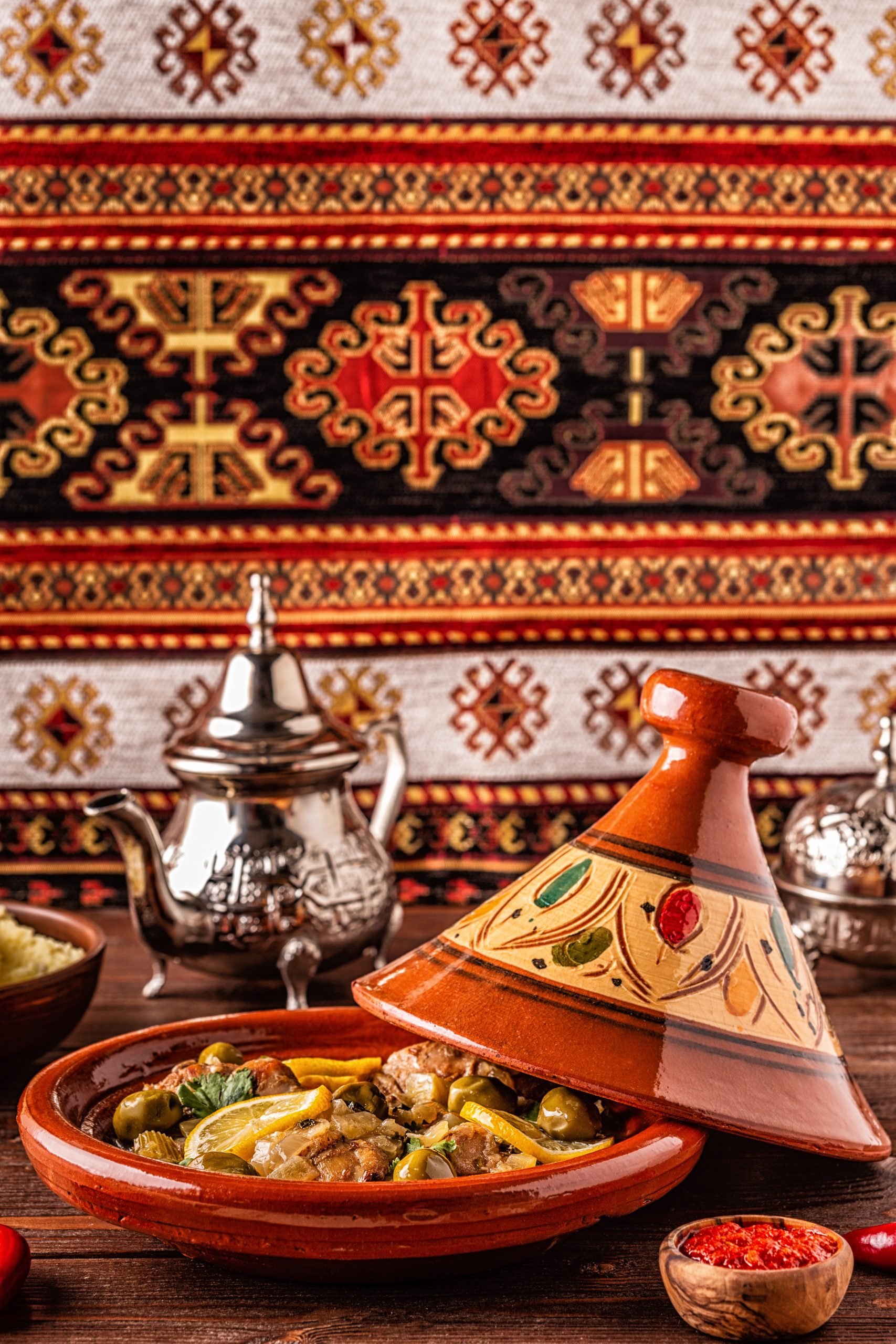 Traditional Moroccan chicken tagine with olives and salted lemons, selective focus.